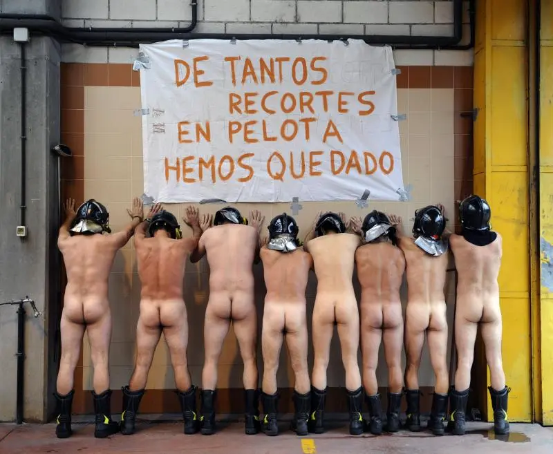Firefighters pose naked in front of a banner during a demonstration against government cuts inside their fire station in Mieres, near Oviedo, northern Spain July 19, 2012. The banner reads, "So many cuts have left us with nothing". REUTERS/Eloy Alonso (SPAIN - Tags: CIVIL UNREST POLITICS SOCIETY) TEMPLATE OUT TELETIPOS_CORREO:%%%,%%%,%%%,SPAIN