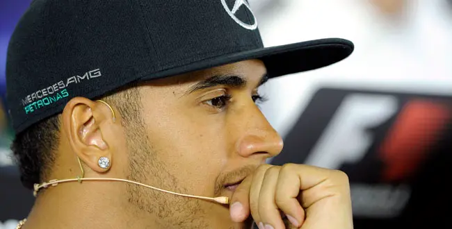 Mercedes driver Lewis Hamilton of Britain rests on his hand as he listens to questions during a press conference ahead of the Australian Formula One Grand Prix at Albert Park in Melbourne, Australia, Thursday, March 13, 2014.