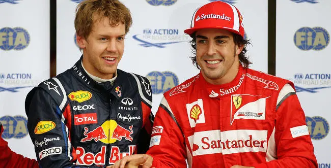 MONTREAL, CANADA - JUNE 11: Pole sitter Sebastian Vettel (L) of Germany and Red Bull Racing celebrates with second placed Fernando Alonso (R) of Spain and Ferrari after qualifying for the Canadian Formula One Grand Prix at the Circuit Gilles Villeneuve on June 11, 2011 in Montreal, Canada. (Photo by Paul Gilham/Getty Images) *** Local Caption *** Sebastian Vettel; Fernando Alonso