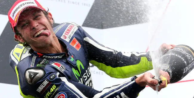 MotoGP rider Valentino Rossi of Italy sprays champagne as he celebrates after winning the Australian Motorcycle Grand Prix at Phillip Island, Australia, Sunday, Oct. 19, 2014.(AP Photo/Rob Griffith)