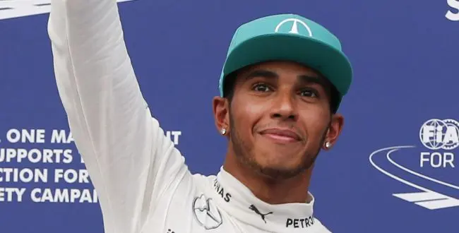 Mercedes driver Lewis Hamilton of Britain waves after pose for photos after qualifying for the Malaysian Formula One Grand Prix at Sepang International Circuit in Sepang, Malaysia, Saturday, March 29, 2014. Hamilton took pole position for the Malaysian Grand Prix on Saturday to tie the record for most qualifying wins by a British driver in Formula One. (AP Photo/Vincent Thian)