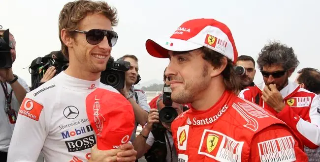 McLaren Formula One driver Jenson Button of Britain and Ferrari Formula One driver Fernando Alonso of Spain chat at the Korean International Circuit as they wait for a group photo at the Korean Grand Prix in Yeongam, South Korea, Thursday, Oct. 21, 2010.