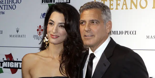 George Clooney and his fiancee Amal Alamuddin pose for photographers as they arrive for the "Celebrity Fight Night" foundation gala dinner, in Florence, Italy, Sunday, Sept. 7, 2014. (AP Photo/Francesco Bellini)