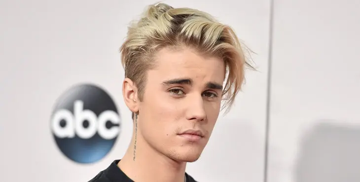 FILE - In this Sunday, Nov. 22, 2015 file photo, Justin Bieber arrives at the American Music Awards at the Microsoft Theater in Los Angeles. With his recent batch of hit singles and semi-grown-up sound - including the electro-pop "Where Are U Now" with DJ-producers Skrillex and Diplo - adult men have begun attending the church of Bieber, and while some have issues admitting it, other proudly say they are Beliebers. “Sorry” and “What Do You Mean,” currently at Nos. 2 and 4 on Billboard’s Hot 100 chart, helped Bieber solidify his comeback after years of a broken image, which included arrests, public smoking and fainting onstage that led to hospitalization. (Photo by Jordan Strauss/Invision/AP, File)