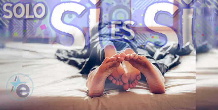 Adult couple's feet looking out of bed