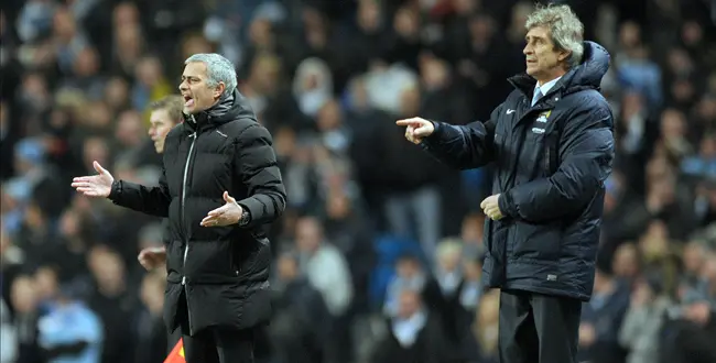Manchester City's manager Manuel Pellegrini, right, and Chelsea's manager Jose Mourinho during their English Premier League soccer match at the Etihad stadium in Manchester, England, Monday Feb. 3, 2014.