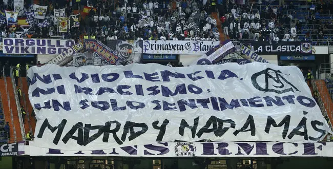 Real Madrid fans show a giant banner reading 'Not, Violence, not rasicm, one single meaning, Madrid and nothing more' during a Group B Champions League soccer match between Real Madrid and Ludogorets at the Santiago Bernabeu stadium in Madrid, Spain, Tuesday, Dec. 9, 2014. (AP Photo/Andres Kudacki)