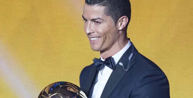 Cristiano Ronaldo of Portugal poses with the trophy after winning the FIFA Men's soccer player of the year 2014 prize at the FIFA Ballon d'Or awarding ceremony at the Kongresshaus in Zurich, Switzerland, Monday, Jan. 12, 2015.