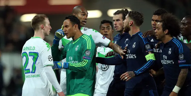 Real Madrid's Costa Rican goalkeeper Keylor Navas (2ndL) argues with Wolfsburg's midfielder Maximilian Arnold (L) during the UEFA Champions League quarter-final, first-leg football match between VfL Wolfsburg and Real Madrid on April 6, 2016 in Wolfsburg, northern Germany.  / AFP / RONNY HARTMANN        (Photo credit should read RONNY HARTMANN/AFP/Getty Images)