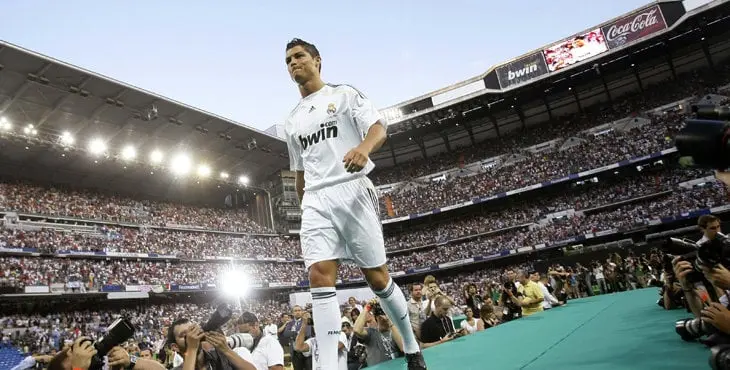 Real Madrid's Portuguese soccer player Cristiano Ronaldo walks onto the stage during his presentation ceremony at Santiago Bernabeu stadium in Madrid, in this July 6, 2009 file picture. In 2009, as the world struggled to emerge from the worst financial crisis in more than half a century, England's Manchester United sold European player of the year Cristiano Ronaldo to Spanish club Real Madrid. The fee: 80 million. To end lavish spending, UEFA has devised new regulations to force clubs to pay out no more than they earn. The new rules, which UEFA calls Financial Fair Play (FFP), begin August 2011 with the start of the European season. Clubs will have two years to begin balancing their books. If they don't meet FFP targets from the 2013/14 season, UEFA says it will expel them from club soccer's premier Champions League competition. That would lose a club tens of millions of euros in television revenue plus the global exposure that helps generate millions more in merchandise sales. To match Special Report SOCCER-FAIRPLAY/ REUTERS/Juan Medina/Files (SPAIN - Tags: SPORT SOCCER)