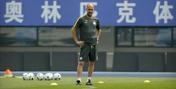 Manchester City manager Pep Guardiola watches his team s training session at the Olympic Sports Center Stadium in Beijing Sunday July 24 2016 Manchester City will play a friendly soccer match against Manchester United in Beijing on Monday night AP Photo Mark Schiefelbein