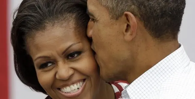President Barack Obama kisses first lady Michelle Obama during a campaign stop , Wednesday, Aug. 15, 2012, in Dubuque, Iowa.