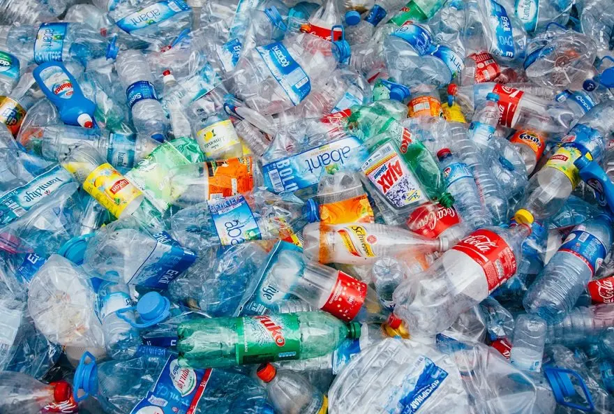Stack of crushed colorful plastic bottles background waiting for recycle
