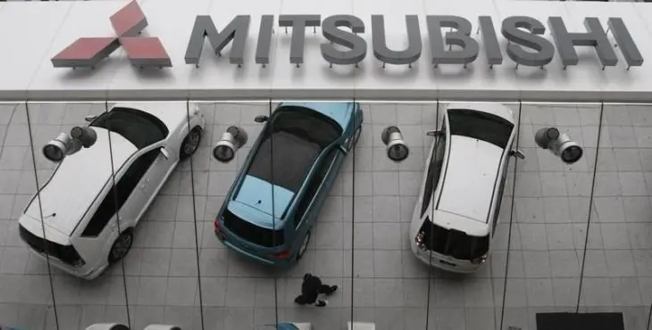 Mitsubishi Motors Corp's vehicles are reflected on an external wall at the company headquarters in Tokyo April 27, 2010. REUTERS/Issei Kato