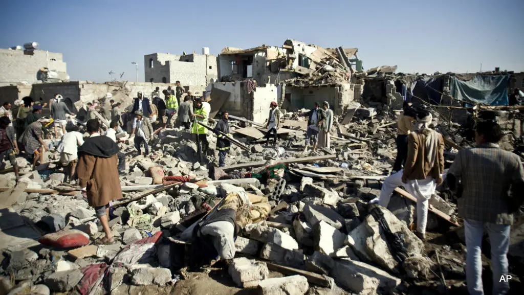 People search for survivors under the rubble of houses destroyed by Saudi airstrikes near Sanaa Airport, Yemen, Thursday, March 26, 2015. Saudi Arabia launched airstrikes Thursday targeting military installations in Yemen held by Shiite rebels who were taking over a key port city in the country's south and had driven the embattled president to flee by sea, security officials said. (AP Photo/Hani Mohammed)