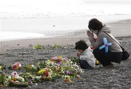 A mother and her daughter offer prayers for victims of the March 11, 2011 earthquake and tsunami disaster at a seaside which was damaged by the disaster in Iwaki, Fukushima prefecture, March 11, 2012, to mark the first anniversary of the earthquake and tsunami that killed thousands and set off a nuclear crisis. REUTERS/Kim Kyung-Hoon