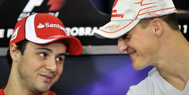 Brazilian F-1 driver Felipe Massa (R) and German Michael Schumacher chat during a press conference at the Interlagos pits on November 24, 2011 in Sao Paulo, Brazil, ahead of the Brazilian Formula One GP next November 27th. AFP PHOTO/NELSON ALMEIDA (Photo credit should read NELSON ALMEIDA/AFP/Getty Images)