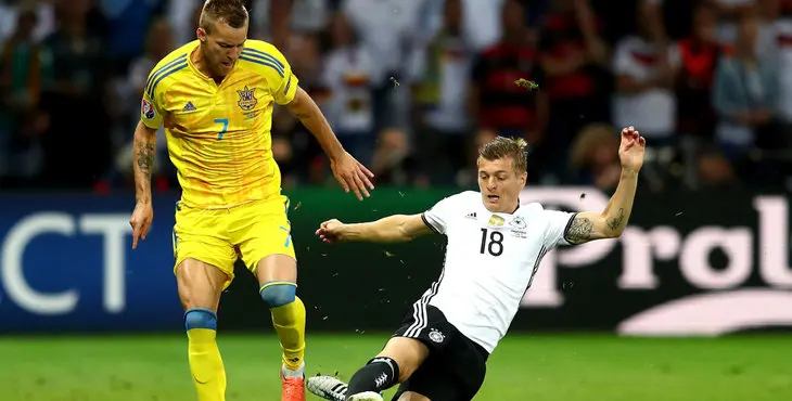 LILLE, FRANCE - JUNE 12: Andriy Yarmolenko of Ukraine and Toni Kroos of Germany compete for the ball during the UEFA EURO 2016 Group C match between Germany and Ukraine at Stade Pierre-Mauroy on June 12, 2016 in Lille, France. (Photo by Clive Mason/Getty Images)