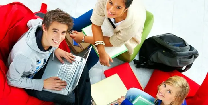 Studygroup relaxing in beanbags while doing school work.