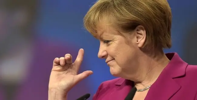 German Chancellor and chairwoman of the German Christian Democrats, CDU, Angela Merkel, points with her fingers during a visit of the convention venue prior to the 27. party convention in Cologne, Germany, Monday, Dec. 8, 2014.
