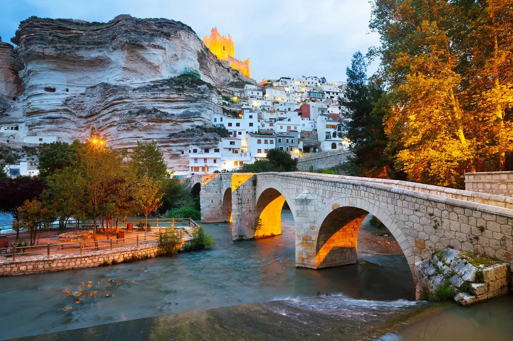 dusk view of Alcala del Jucar with   river and bridge. Province of Albacete, Spain