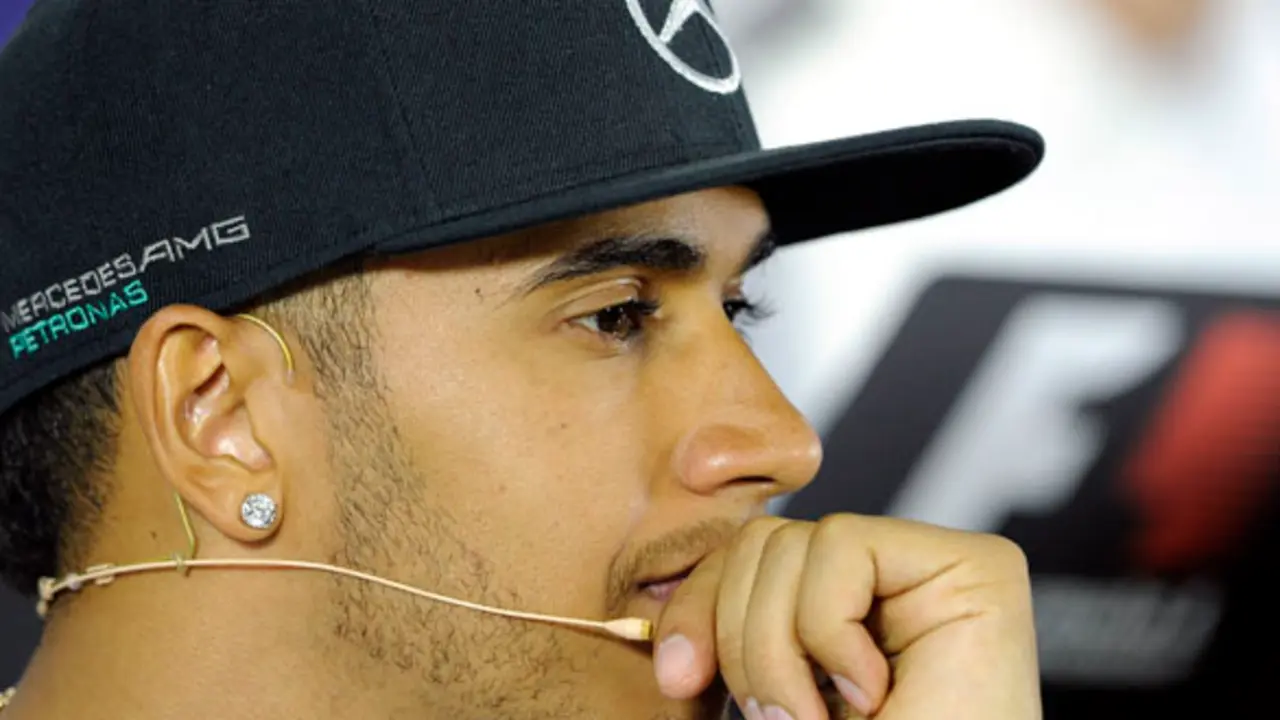 Mercedes driver Lewis Hamilton of Britain  rests on his hand as he listens to questions during a press conference ahead of the Australian Formula One Grand Prix at Albert Park in Melbourne, Australia, Thursday, March 13, 2014.