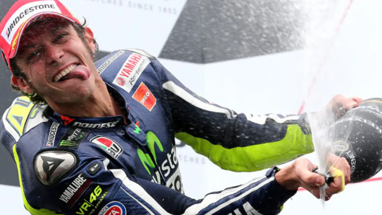 MotoGP rider Valentino Rossi of Italy sprays champagne as he celebrates after winning the Australian Motorcycle Grand Prix at Phillip Island, Australia, Sunday, Oct. 19, 2014.(AP Photo/Rob Griffith)