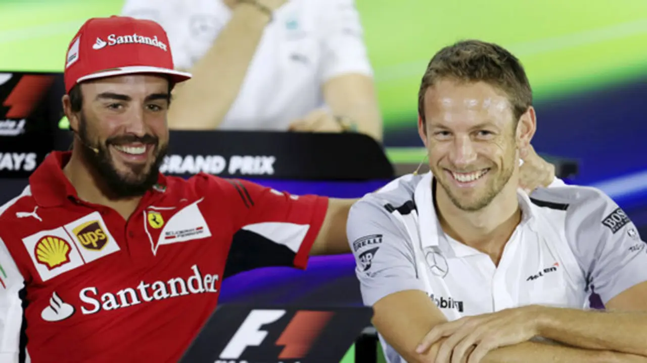 Ferrari driver Fernando Alonso and McLaren Mercedes driver Jenson Button share a lighter moment during a news conference at the Yas Marina racetrack in Abu Dhabi, United Arab Emirates, Thursday, Nov. 20, 2014.
