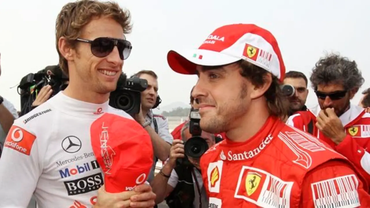 McLaren Formula One driver Jenson Button of Britain  and Ferrari Formula One driver Fernando Alonso of Spain chat at the Korean International Circuit as they wait for a group photo at the Korean Grand Prix in Yeongam, South Korea, Thursday, Oct. 21, 2010.
