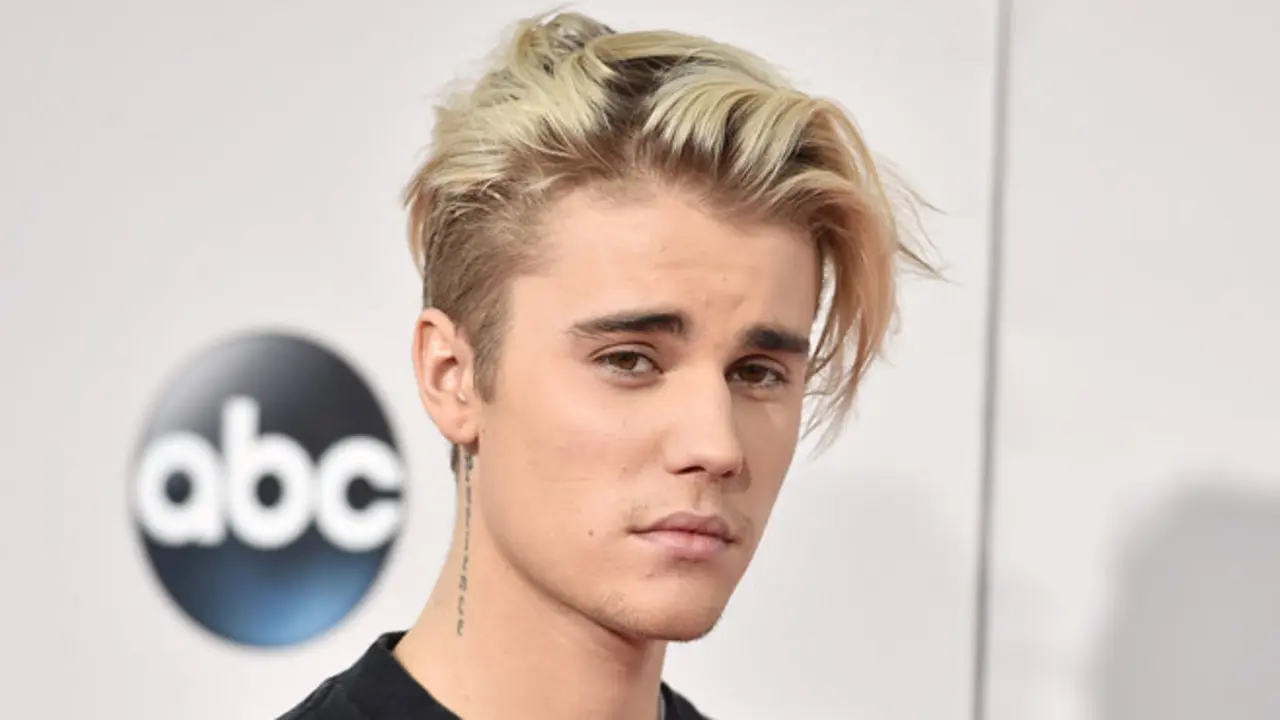 FILE - In this Sunday, Nov. 22, 2015 file photo, Justin Bieber arrives at the American Music Awards at the Microsoft Theater in Los Angeles. With his recent batch of hit singles and semi-grown-up sound  - including the electro-pop "Where Are U Now" with DJ-producers Skrillex and Diplo - adult men have begun attending the church of Bieber, and while some have issues admitting it, other proudly say they are Beliebers. “Sorry” and “What Do You Mean,” currently at Nos. 2 and 4 on Billboard’s Hot 100 chart, helped Bieber solidify his comeback after years of a broken image, which included arrests, public smoking and fainting onstage that led to hospitalization. (Photo by Jordan Strauss/Invision/AP, File)