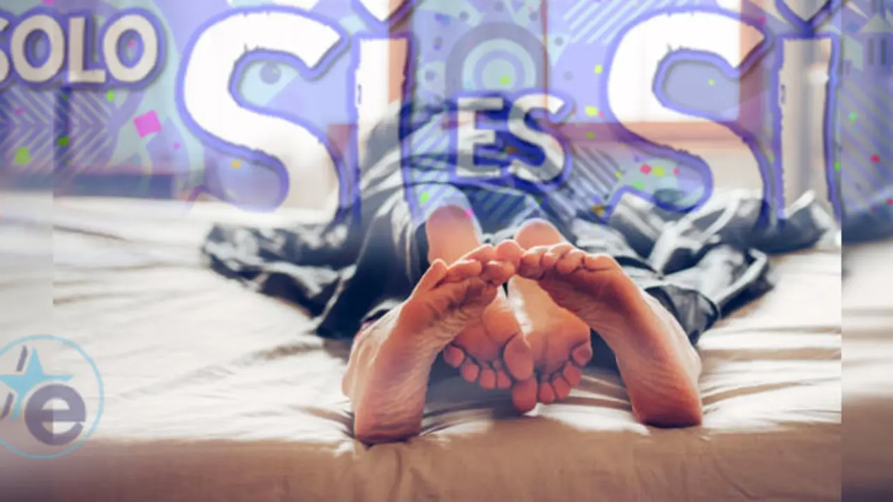 Adult couple's feet looking out of bed