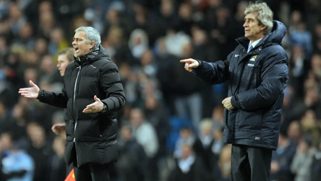 Manchester City's manager Manuel Pellegrini, right, and Chelsea's manager Jose Mourinho during their English Premier League soccer match at the Etihad stadium in Manchester, England, Monday Feb. 3, 2014.