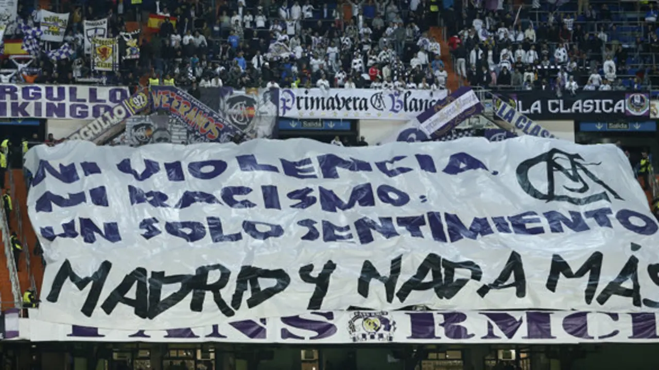 Real Madrid fans show a giant banner reading 'Not, Violence, not rasicm, one single meaning, Madrid and nothing more' during a Group B Champions League soccer match between Real Madrid and Ludogorets at the Santiago Bernabeu stadium in Madrid, Spain, Tuesday, Dec. 9, 2014. (AP Photo/Andres Kudacki)