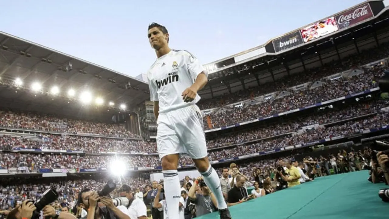 Real Madrid's Portuguese soccer player Cristiano Ronaldo walks onto the stage during his presentation ceremony at Santiago Bernabeu stadium in Madrid, in this July 6, 2009 file picture. In 2009, as the world struggled to emerge from the worst financial crisis in more than half a century, England's Manchester United sold European player of the year Cristiano Ronaldo to Spanish club Real Madrid. The fee: 80 million. To end lavish spending, UEFA has devised new regulations to force clubs to pay out no more than they earn. The new rules, which UEFA calls Financial Fair Play (FFP), begin August 2011 with the start of the European season. Clubs will have two years to begin balancing their books. If they don't meet FFP targets from the 2013/14 season, UEFA says it will expel them from club soccer's premier Champions League competition. That would lose a club tens of millions of euros in television revenue plus the global exposure that helps generate millions more in merchandise sales.   To match Special Report SOCCER-FAIRPLAY/        REUTERS/Juan Medina/Files (SPAIN  - Tags: SPORT SOCCER)