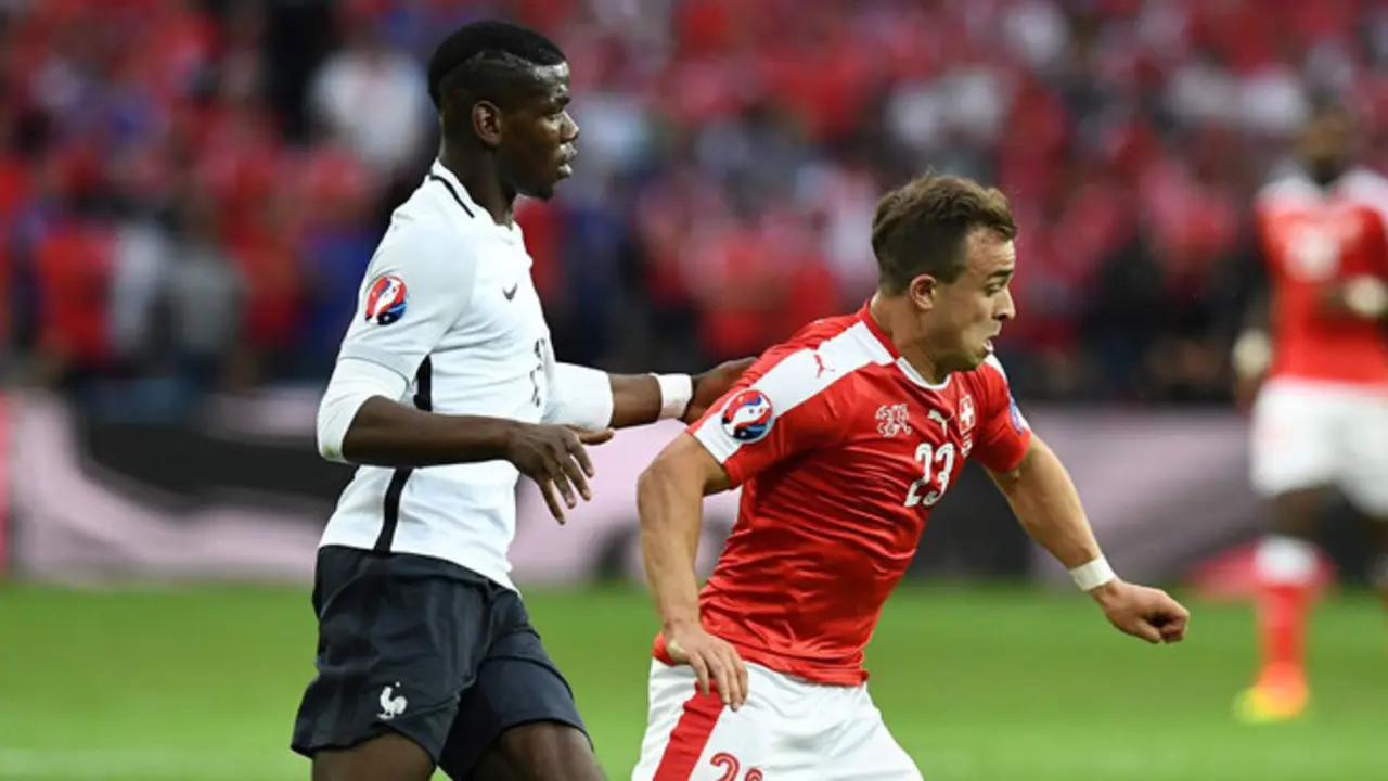 France's midfielder Paul Pogba (L) vies for the ball against Switzerland's midfielder Xherdan Shaqiri during the Euro 2016 group A football match between Switzerland and France at the Pierre-Mauroy stadium in Lille on June 19, 2016. / AFP / FRANCK FIFE        (Photo credit should read FRANCK FIFE/AFP/Getty Images)