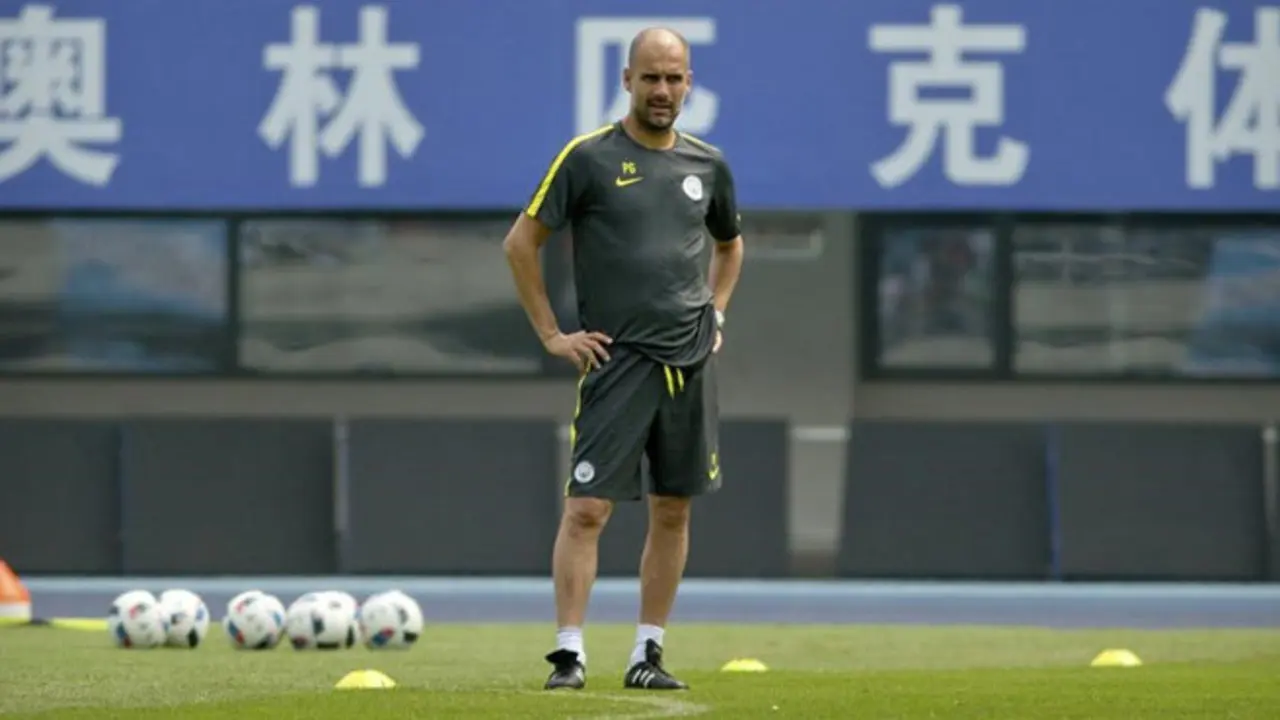 Manchester City manager Pep Guardiola watches his team s training session at the Olympic Sports Center Stadium in Beijing  Sunday  July 24  2016  Manchester City will play a friendly soccer match against Manchester United in Beijing on Monday night   AP Photo Mark Schiefelbein