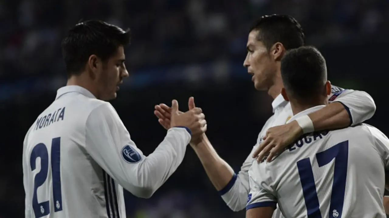 Real Madrid's midfielder Lucas Vazquez (R), Real Madrid's forward Alvaro Morata (L) and Real Madrid's Portuguese forward Cristiano Ronaldo celebrate after scoring a goal during the UEFA Champions League football match Real Madrid CF vs Legia  Legia Warszawa at the Santiago Bernabeu stadium in Madrid on October 18, 2016. / AFP / JAVIER SORIANO        (Photo credit should read JAVIER SORIANO/AFP/Getty Images)