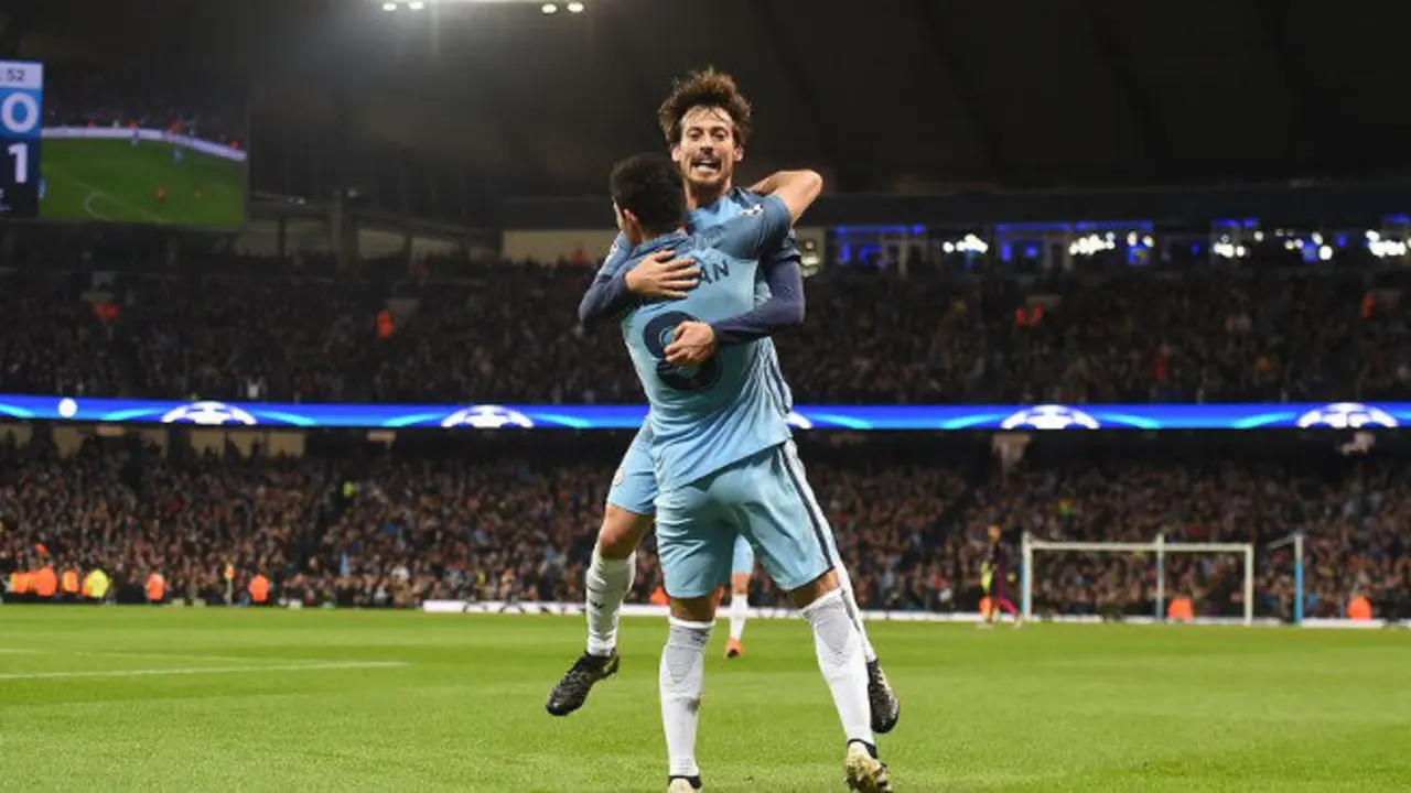 Manchester City's German midfielder Ilkay Gundogan (R) celebrates with Manchester City's Spanish midfielder David Silva after scoring his team's first goal during the UEFA Champions League group C football match between Manchester City and Barcelona at the Etihad Stadium in Manchester, north west England on November 1, 2016. / AFP / PAUL ELLIS        (Photo credit should read PAUL ELLIS/AFP/Getty Images)