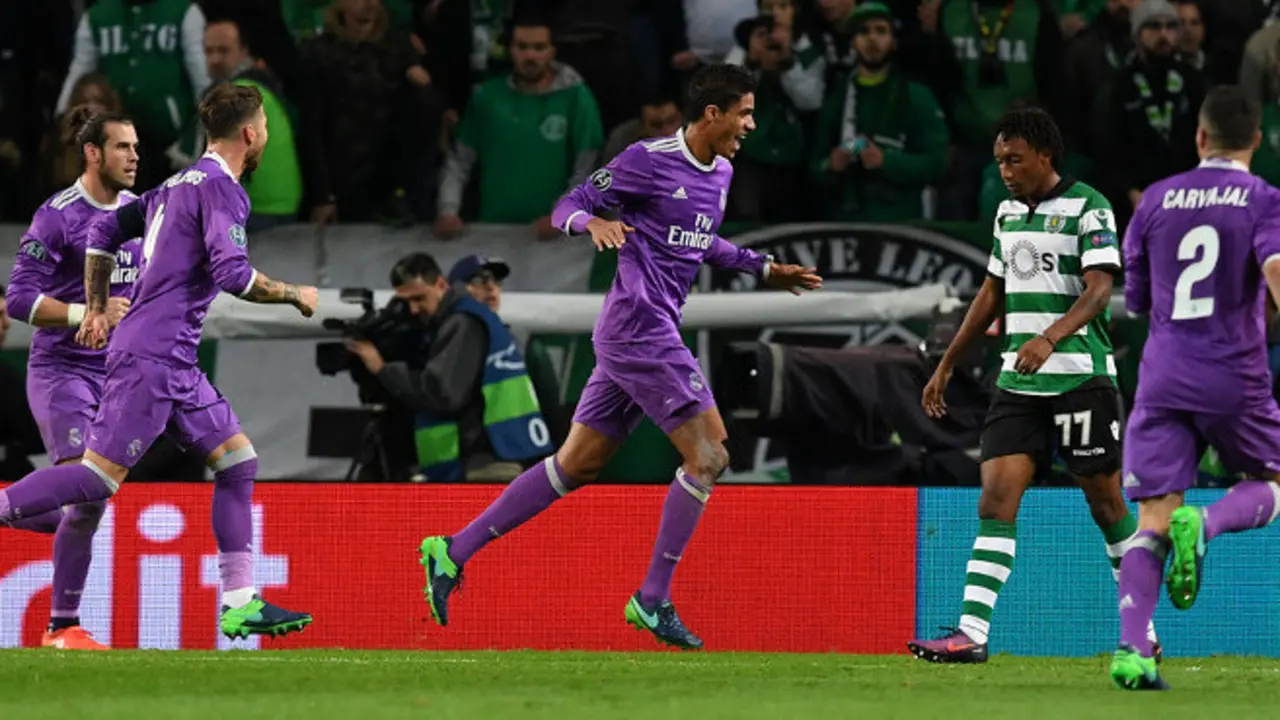 Real Madrid's defender Raphael Varane (C) celebrates after scoring the opening goal during the UEFA Champions League football match Sporting CP vs Real Madrid CF at the Jose Alvalade stadium in Lisbon on November 22, 2016. / AFP / FRANCISCO LEONG        (Photo credit should read FRANCISCO LEONG/AFP/Getty Images)