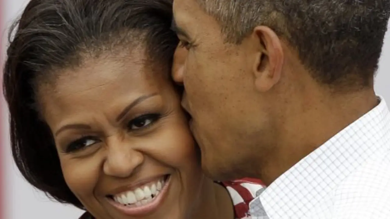 President Barack Obama kisses first lady Michelle Obama during a campaign stop , Wednesday, Aug. 15, 2012, in Dubuque, Iowa.
