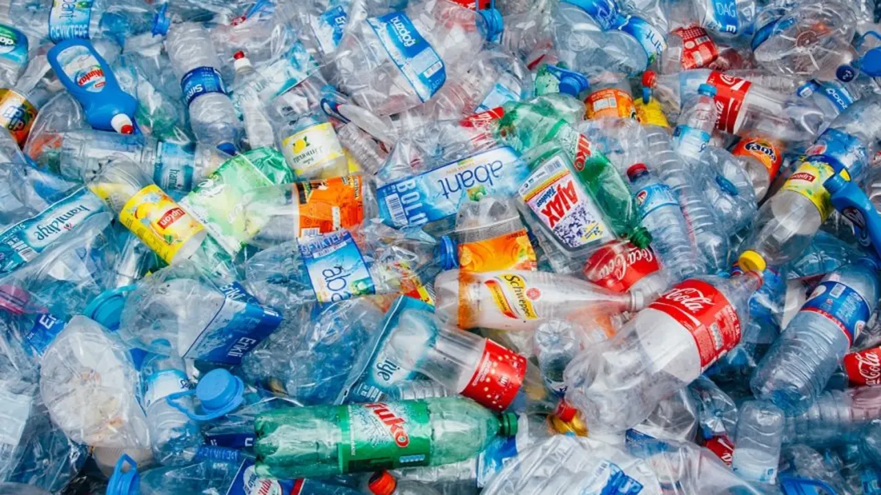Stack of crushed colorful plastic bottles background waiting for recycle