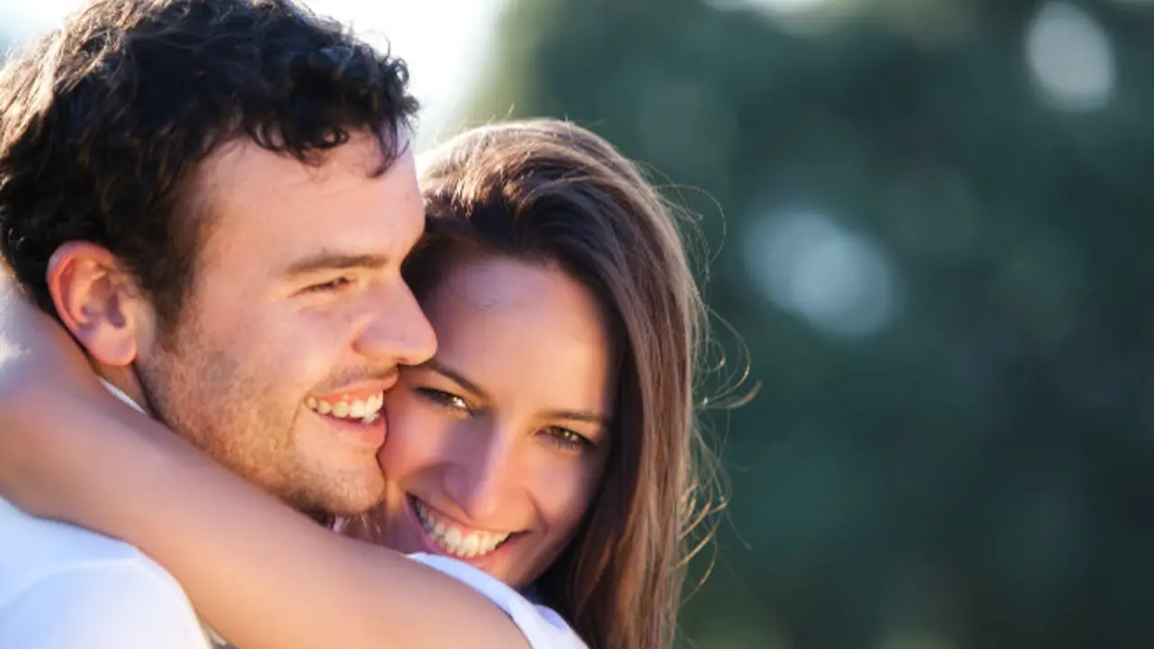 Closeup on young beautiful smiling couple.