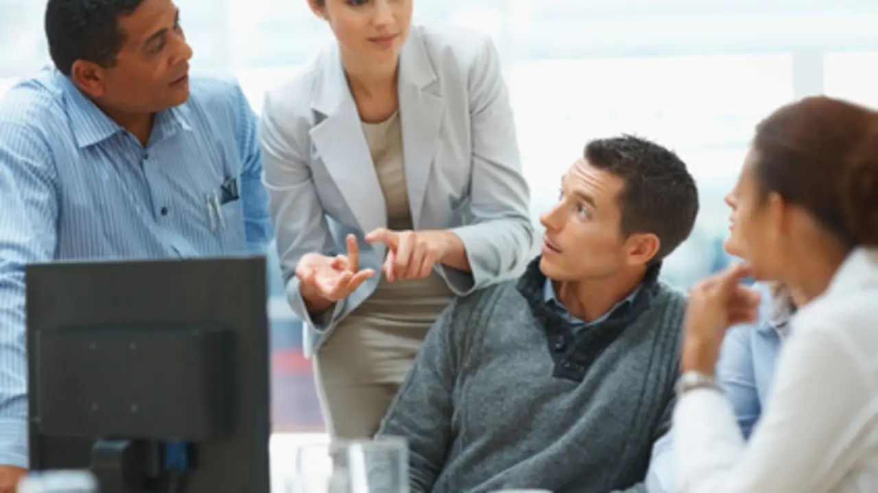 Portrait of confident business woman explaining a project to colleagues