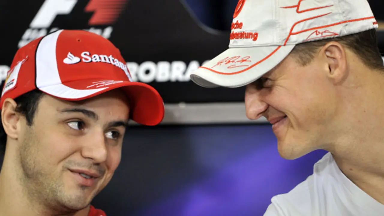 Brazilian F-1 driver Felipe Massa (R) and German Michael Schumacher chat during a press conference  at the Interlagos pits on November 24, 2011 in Sao Paulo, Brazil, ahead of the Brazilian Formula One GP next November 27th. AFP PHOTO/NELSON ALMEIDA (Photo credit should read NELSON ALMEIDA/AFP/Getty Images)