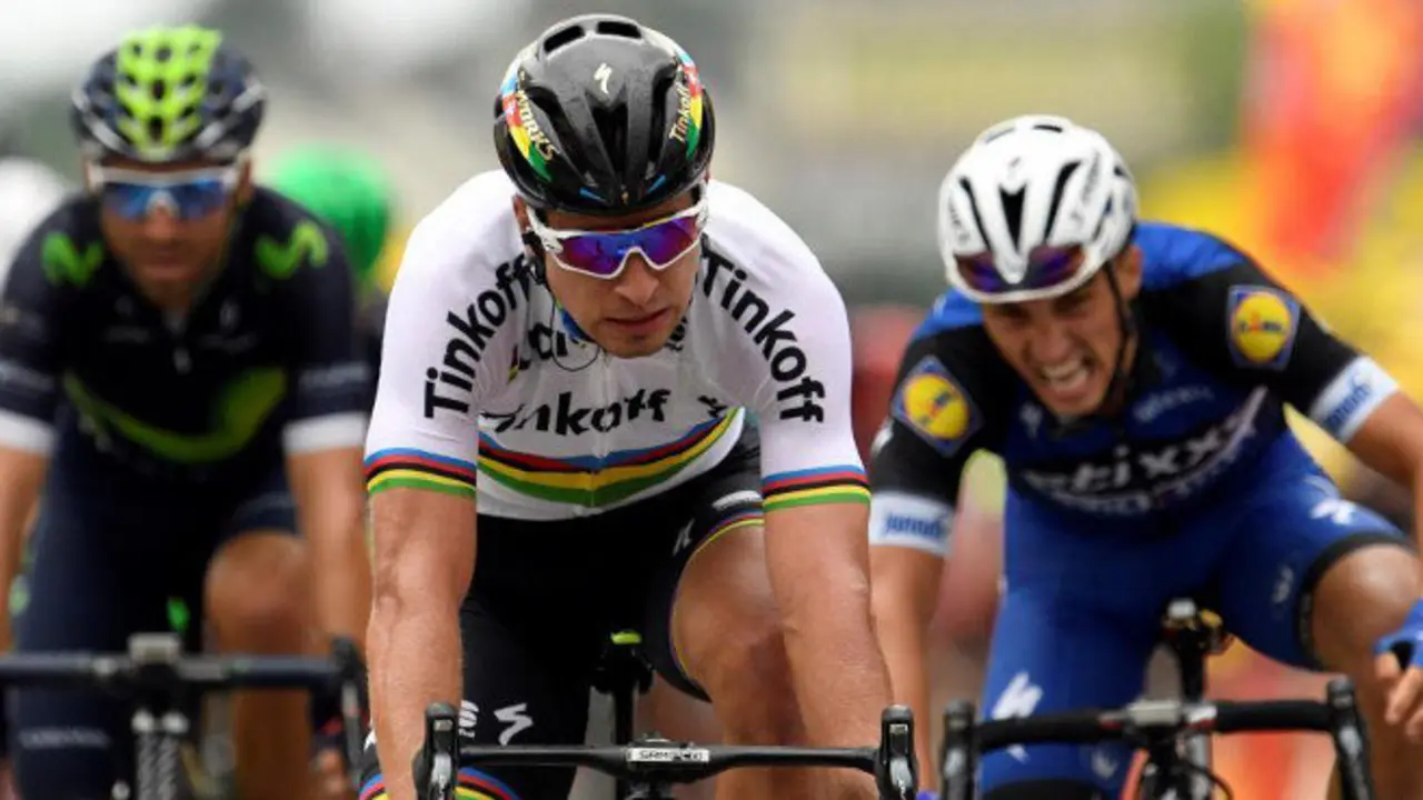 Slovakia's Peter Sagan (C) crosses the finish line ahead of France's Julian Alaphilippe (R) and Spain's Alejandro Valverde (L) at the end of the 183 km second stage of the 103rd edition of the Tour de France cycling race on July 3, 2016 between Saint-Lo and Cherbourg-en-Cotentin, Normandy. / AFP PHOTO / LIONEL BONAVENTURE
