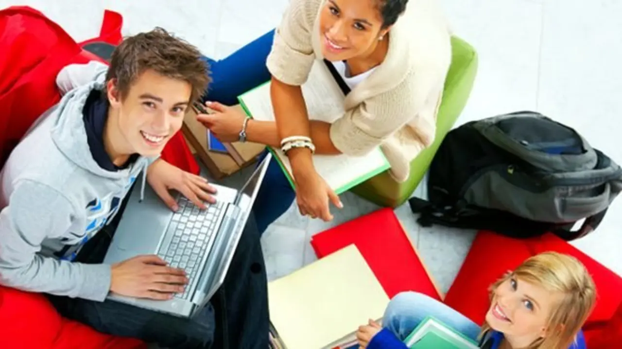 Studygroup relaxing in beanbags while doing school work.