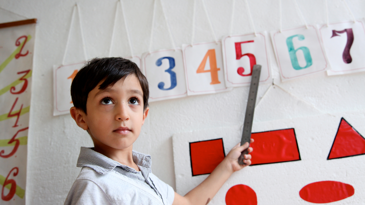 2011, Southern city of Lenkaran. UNICEF supported pre-school #9. A boy learns how to read numbers on her first day in school after the summer holidays.