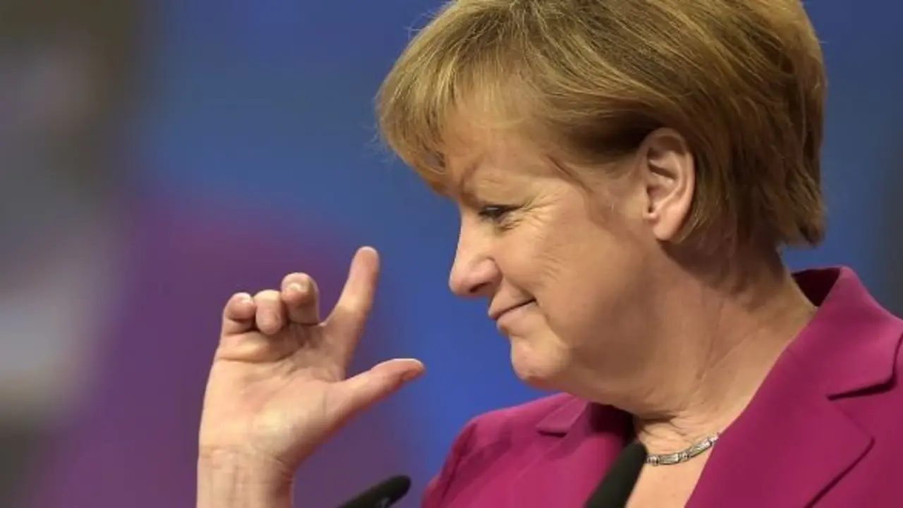 German Chancellor and chairwoman of the German Christian Democrats, CDU, Angela Merkel, points with her fingers during a visit of the  convention venue prior to  the 27. party convention in Cologne, Germany, Monday, Dec. 8, 2014.