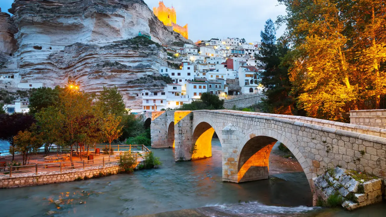dusk view of Alcala del Jucar with   river and bridge. Province of Albacete, Spain