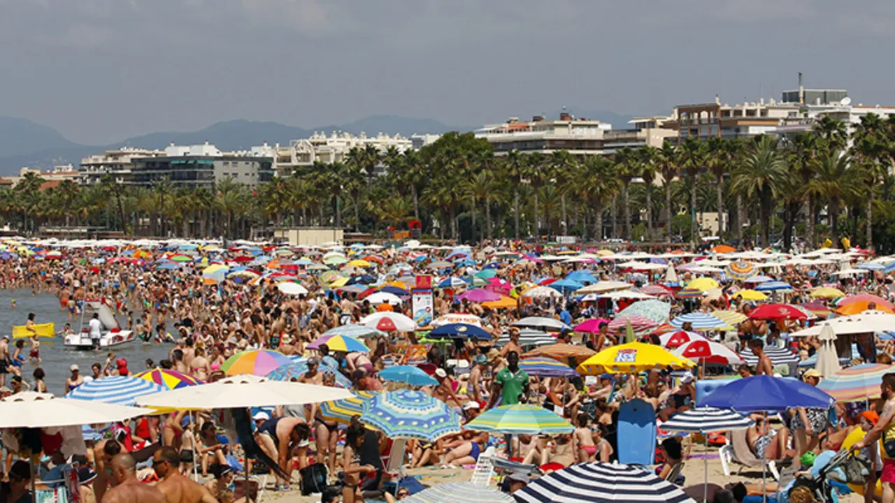 People relaxing and having fun on the beach of Salou, Spain